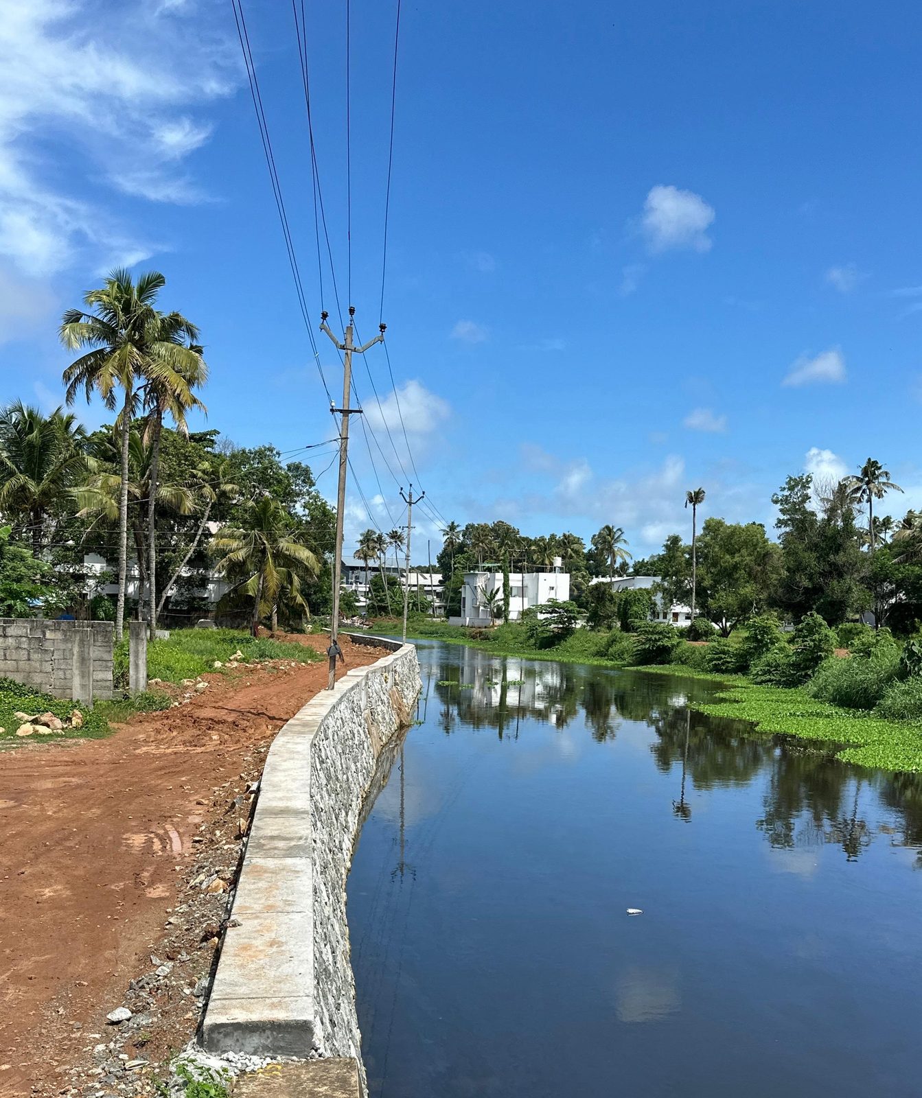 Stone pitched bank wall with a concrete coping along the Kilikollur thodu at Choorangal